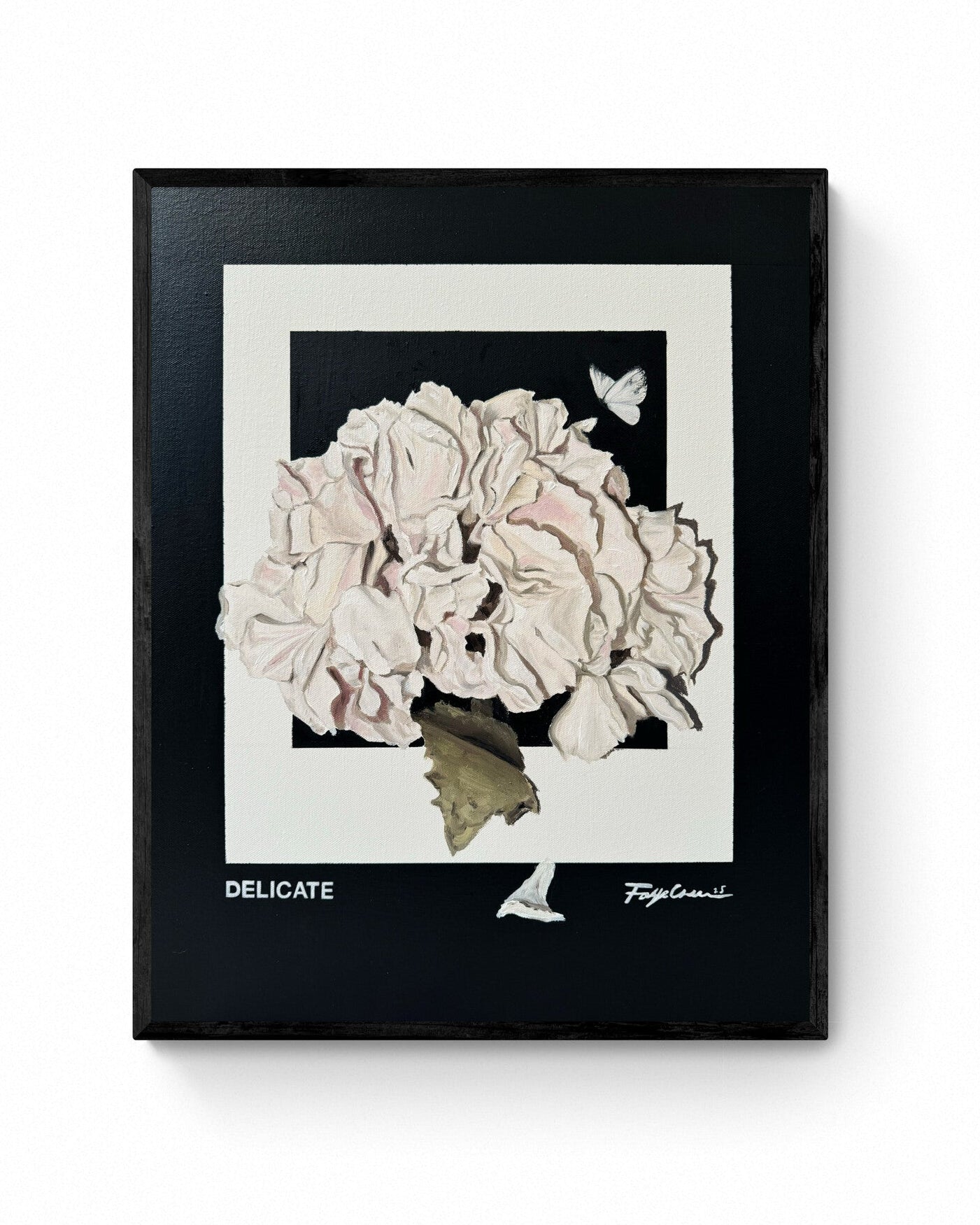 A framed painting of a floral arrangement with the word 'DELICATE' prominently displayed. The artwork is protected by a satin varnish and set against a black background.
